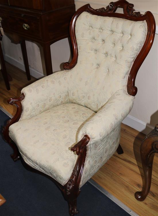 A Victorian style carved walnut armchair and another similar chair